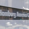 Schriftzug ‚Hamburg America Center‘ an moderner Gebäudefassade.